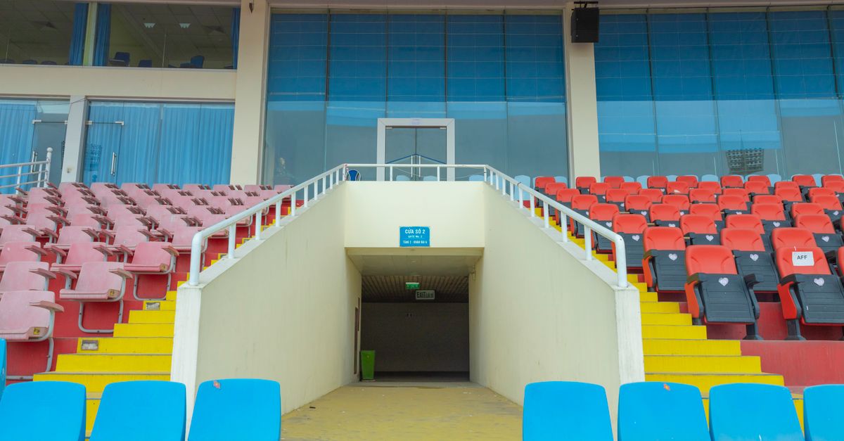 Vibrant stadium seats arranged in an empty arena highlighting architecture.